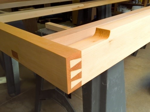 Completed bed frame half blind dovetail joint corner with first coat of finish